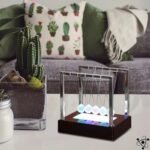 pendule de newton lumineux eblouissant pour decoration socle marron 740 1